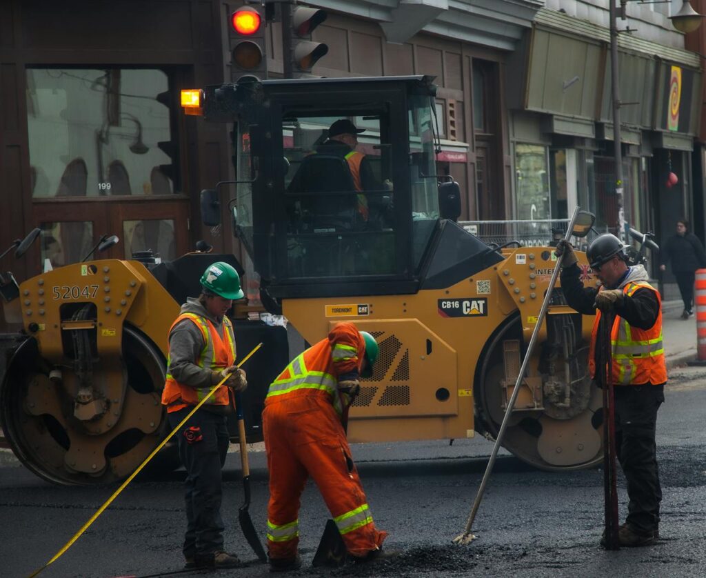 pexels-photo-15437562 Workers and machinery paving a road in urban Québec City, Canada.