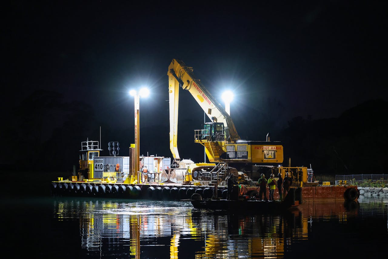 Dredging operation at Stamford Marina illuminated in the night.