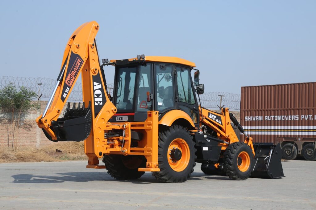 pexels-photo-29543012 ACE AX 124 backhoe loader on a sunny day at Faridabad construction site.
